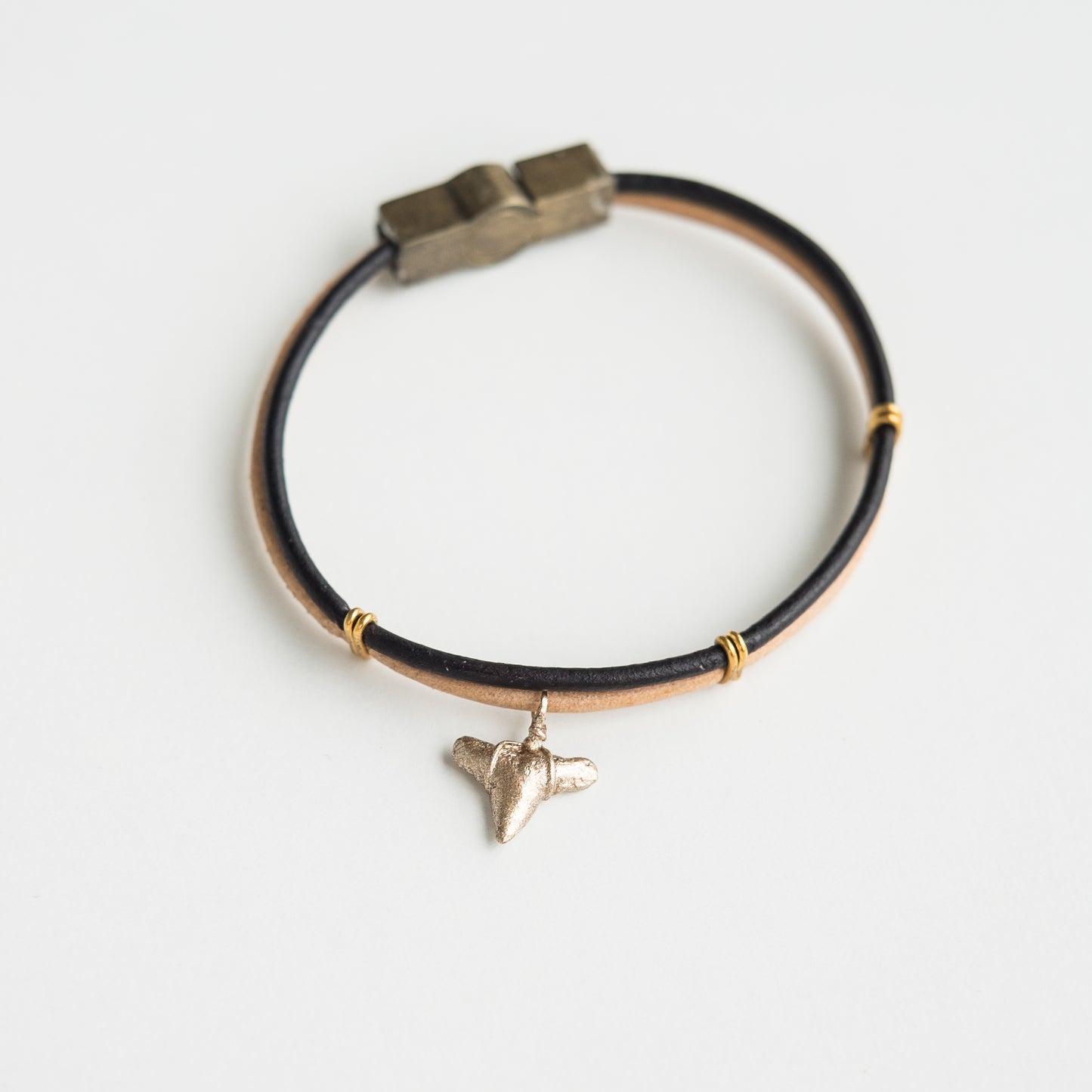 gold shark tooth charm bracelet on 2 tone leather straps