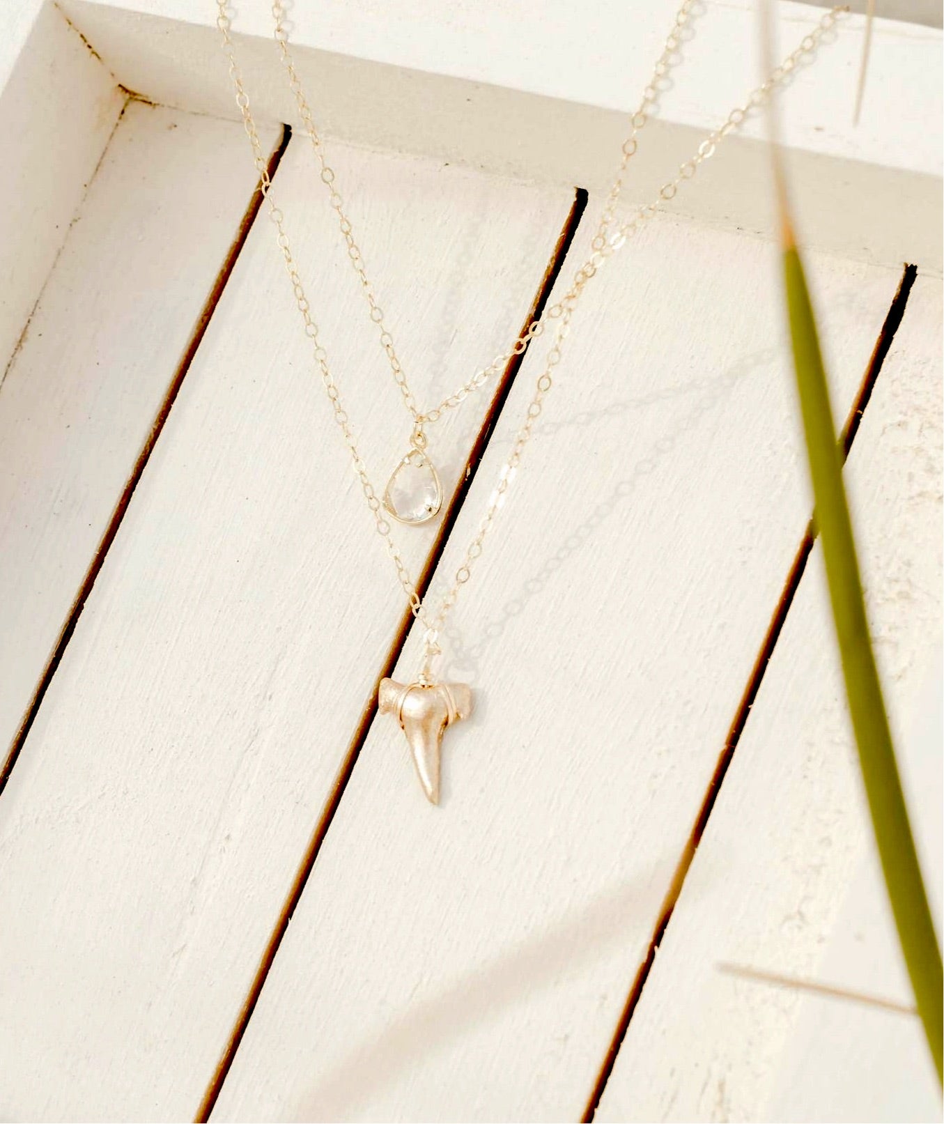 2 layer gold shark tooth necklace with quartz crystal