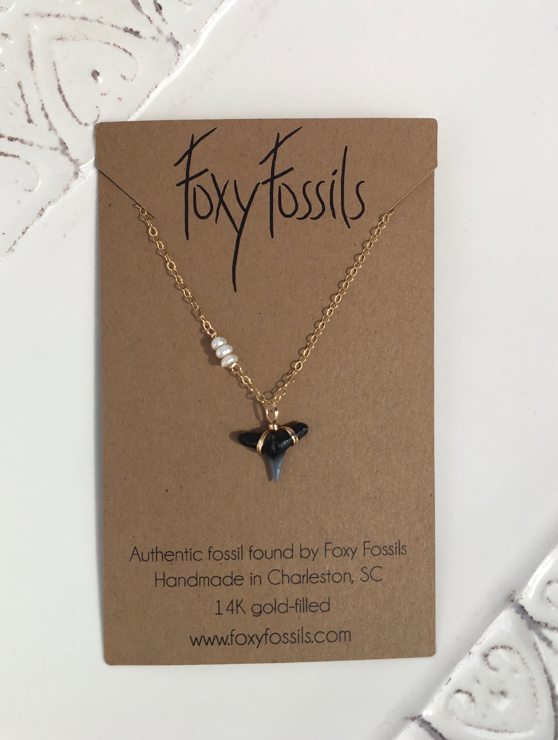 dainty gold wire wrapped shark tooth necklace with tiny off center pearls—ethically sourced fossilized shark tooth pendant—Foxy Fossils 