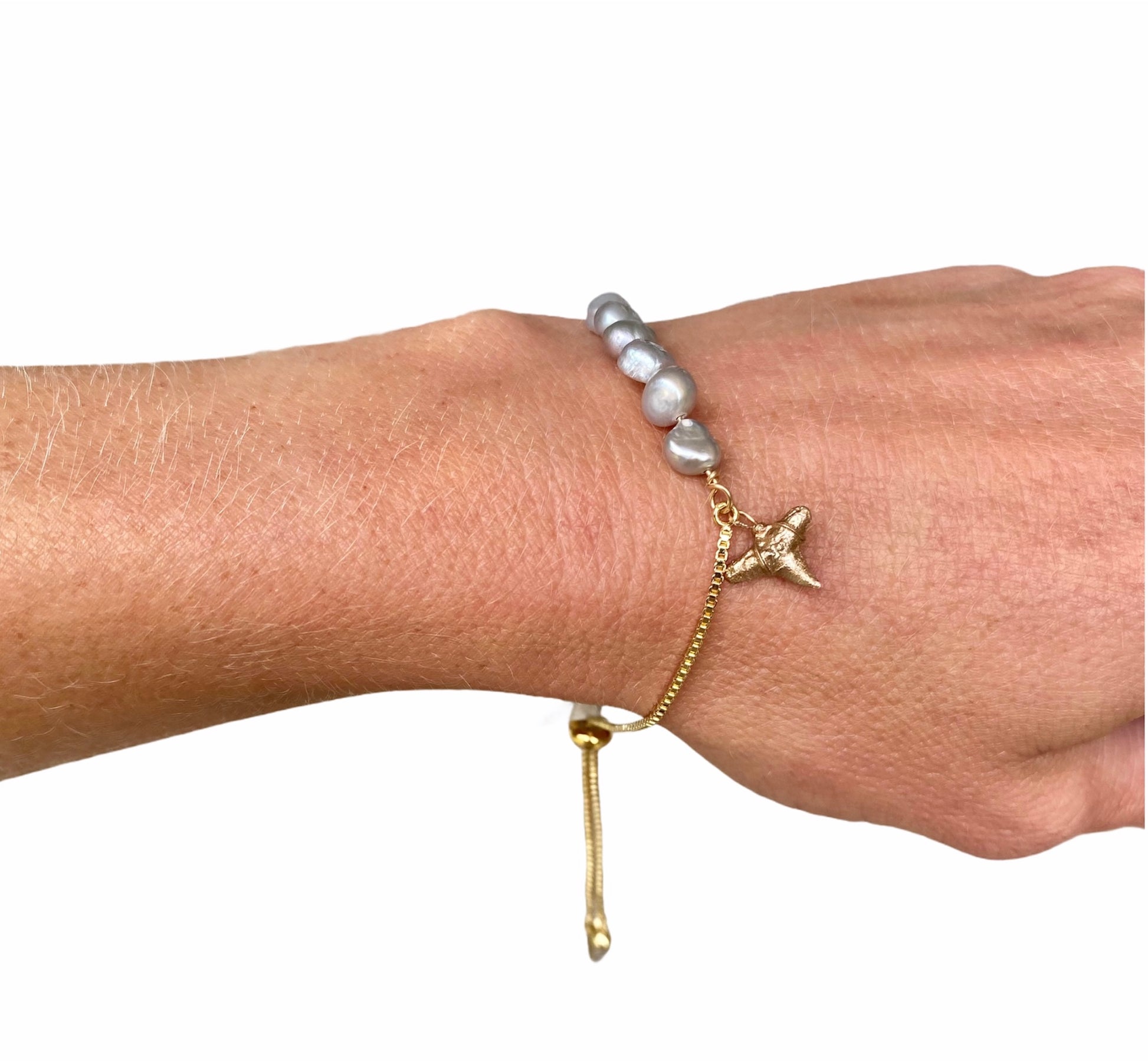 ethical and sustainable real shark tooth fossil charm in gold on adjustable gold bracelet with light grey pearls-Foxy Fossils