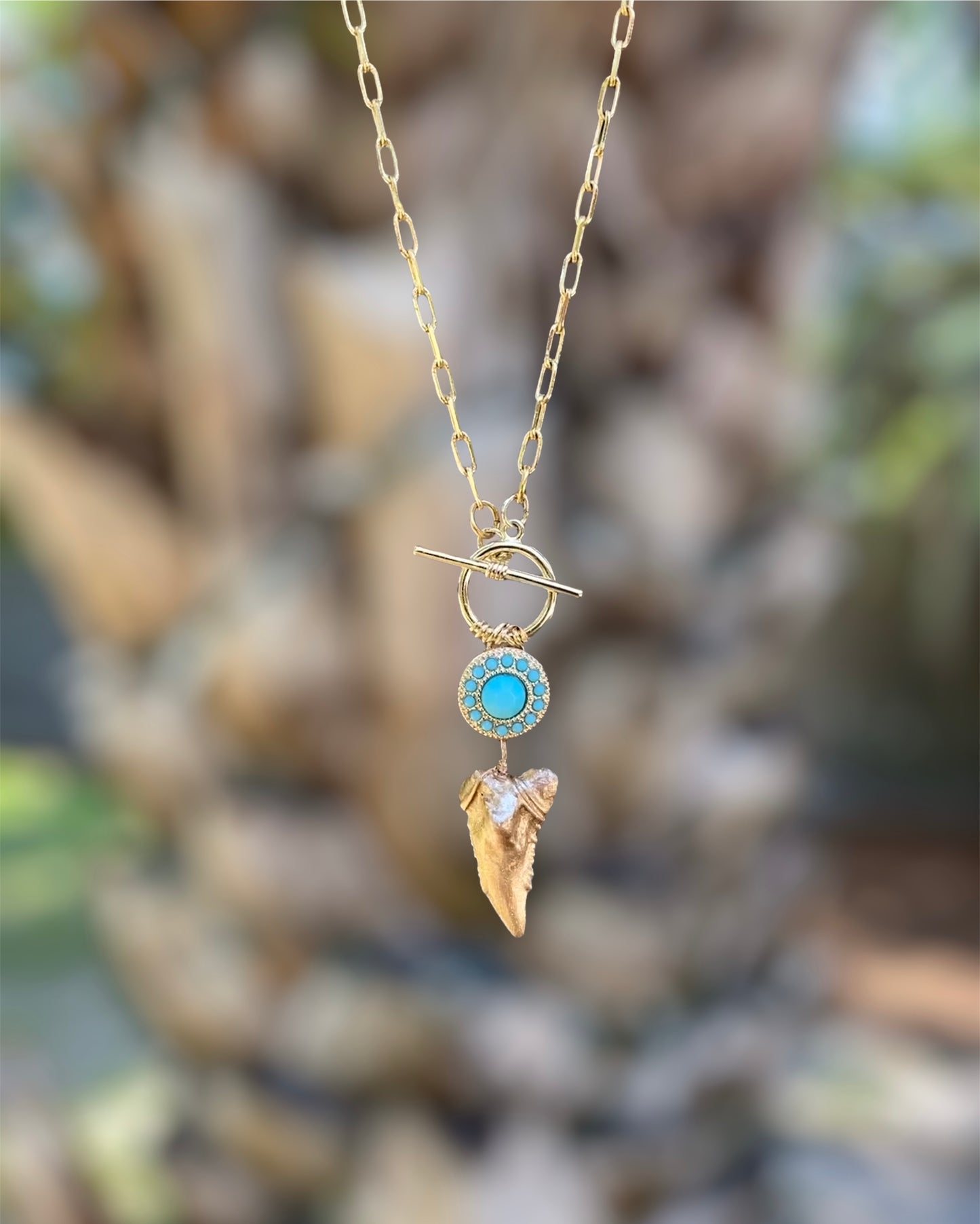 gold shark tooth statement necklace, gold snaggletooth pendant on link chain with turquoise, foxy fossils