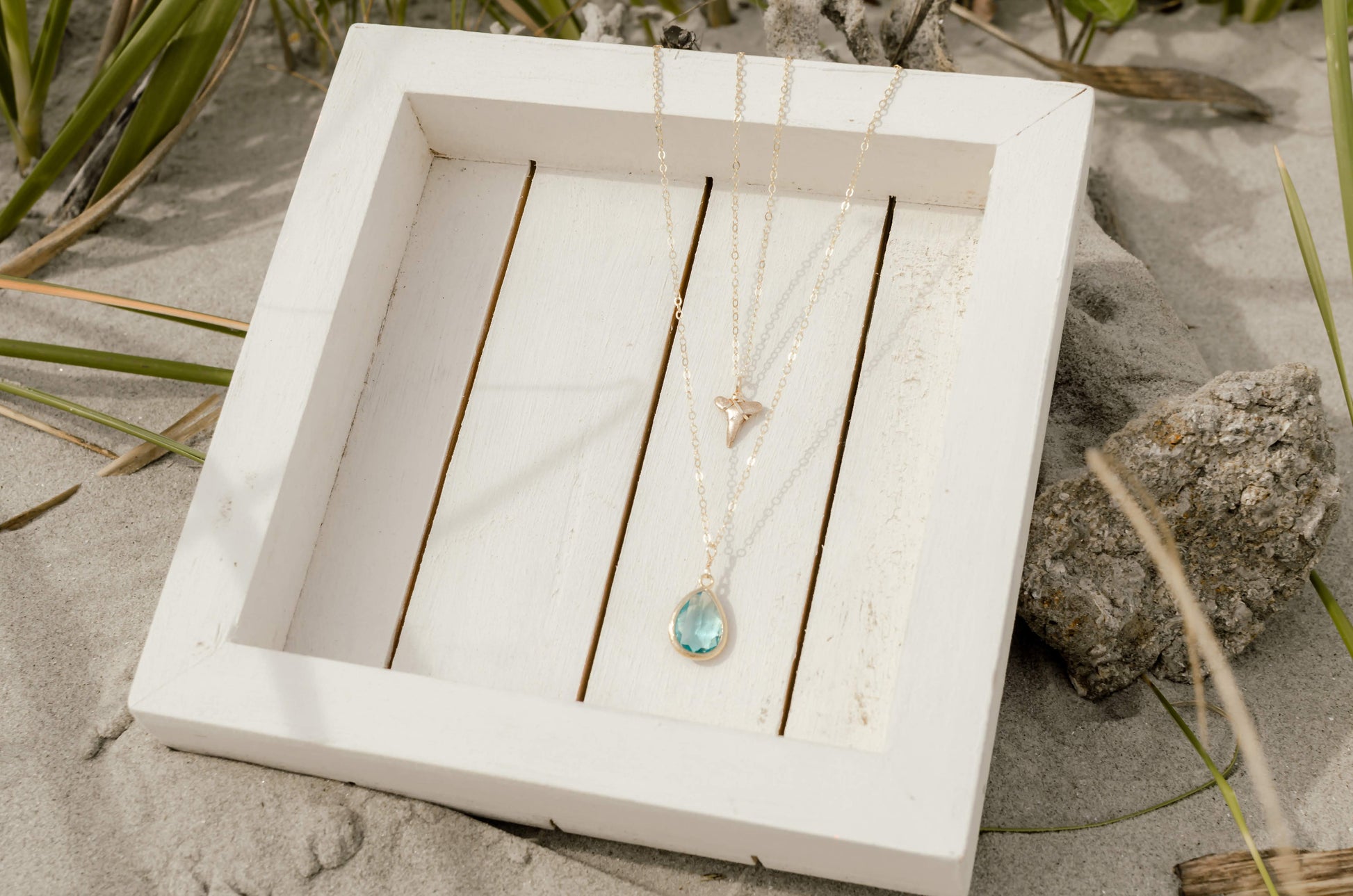 layered gold shark tooth necklace and aqua stone
